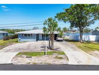 Aerial shot of updated home showing the long driveway and waterfront view at 140 Crestview Dr, Englewood, FL 34223