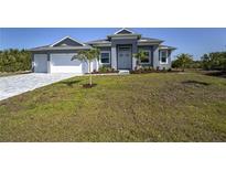 Beautiful single-story home with a well-manicured lawn and inviting entrance at 14526 Fort Worth Cir, Port Charlotte, FL 33981