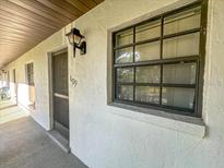Exterior view of unit 609 featuring a light fixture and window at 149 Englewood Isles Pkwy # 609, Englewood, FL 34223
