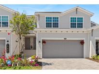 Charming townhome featuring an attached garage, well-maintained landscaping, and inviting front entrance at 17685 Boracay Ct # 202, Venice, FL 34293