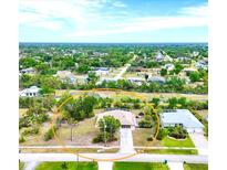 Charming home featuring a long driveway and lush landscaping, nestled in a quiet neighborhood at 533 Boundary Blvd, Rotonda West, FL 33947