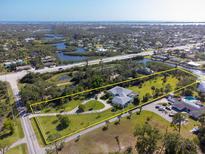 Beautiful waterfront property with a large lot, circular driveway, and stunning views of the surrounding area at 60 N Oxford Dr, Englewood, FL 34223