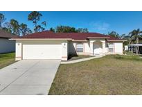 Charming single-story home with a two-car garage and a well-maintained lawn at 7193 Carvel St, Englewood, FL 34224