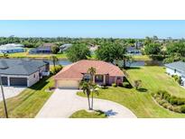 Waterfront home with well-maintained lawn and large circular driveway at 1080 Boundary Blvd, Rotonda West, FL 33947