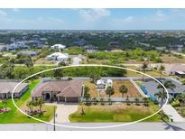 Sprawling home with large lot, RV parking, and tropical landscaping at 14527 Maysville Cir, Port Charlotte, FL 33981