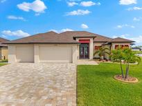 Stunning single-Gathering home with a three-car garage, complemented by lush green grass and beautiful palm trees at 15588 Ruston Cir, Port Charlotte, FL 33981