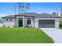 Beautiful, single-story home with a manicured lawn, gray roof, and neutral exterior paint at 1826 Narrington Ave, North Port, FL 34288