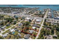 Aerial view of a home with a sprawling, tree-filled yard, surrounded by streets and waterways at 2033 Georgia Ave, Englewood, FL 34224