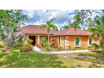 Charming single-story home featuring a well-maintained lawn and lush landscaping at 2700 Sheboygan Ave, North Port, FL 34286