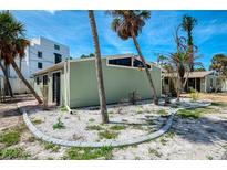 Charming single-story home featuring landscaped yard, palm trees and an architectural angular roof at 2980 N Beach Rd # Gv16, Englewood, FL 34223