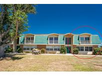 Inviting two-story condo with a vibrant green roof and lush landscaping with a private balcony for outdoor enjoyment at 3586 Cape Haze N Dr # B6, Rotonda West, FL 33947