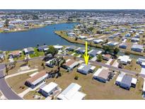 Enjoy waterfront views from this home in Lemon Bay Isles, a 55+ community near beautiful lakes at 6168 Partridge Ave, Englewood, FL 34224