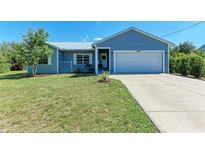 Charming single-story home featuring a well-maintained lawn, attached garage, and beautiful curb appeal at 7360 David Blvd, Port Charlotte, FL 33981