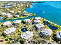 Stunning aerial view of waterfront condos with beautiful landscaping and access to the bay and intercoastal waterway at 11000 Placida Rd # 2702, Placida, FL 33946