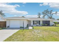 Charming single-story home with a well-manicured lawn, attached garage, and lovely curb appeal at 1365 Sussex Rd, Venice, FL 34293