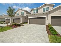 Charming exterior of home showing the paved driveway and two-car garage in well-maintained community at 17645 Boracay Ct # 202, Venice, FL 34293