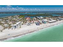 Breathtaking aerial view showcasing the beachfront property with turquoise waters and white sandy beach access at 2769 N Beach Rd # 105, Englewood, FL 34223