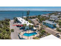 Beautiful waterfront condo with a swimming pool and well manicured tropical landscaping at 5055 N Beach Rd # 208, Englewood, FL 34223