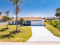 Charming single-story home boasts a manicured lawn and a spacious driveway at 5232 Conner Ter, Port Charlotte, FL 33981