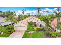 Charming single-story home with a tile roof, paver driveway, and beautifully landscaped front yard at 5433 White Ibis Dr, North Port, FL 34287