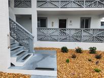 Charming condo building featuring gray lattice details, a well-maintained exterior, and inviting landscaping at 6800 Placida Rd # 1004, Englewood, FL 34224