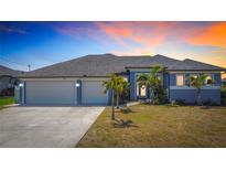Charming single-story home with a three-car garage, well-manicured lawn, and tasteful landscaping at 1167 Rotonda Cir, Rotonda West, FL 33947