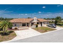 Charming single story home featuring a well-manicured lawn, cozy courtyard and private driveway at 13100 S Mccall Rd # 112, Port Charlotte, FL 33981
