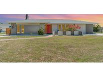 Charming single-story home featuring a well-maintained lawn and vibrant landscaping at 2140 Carnac St, Port Charlotte, FL 33952