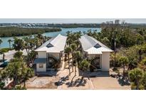 Waterfront two-story condos boast metal roofs, outdoor staircases, and lush landscaping at 2450 N Beach Rd # 231, Englewood, FL 34223