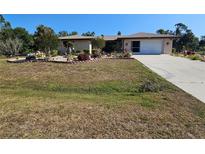 Charming one-story home with a two car garage and lovely landscaping at 2650 Colonade Ln, North Port, FL 34286