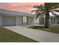 Charming single-story home featuring a well-maintained lawn and a classic driveway leading to an attached garage at 3246 Yukon Dr, Port Charlotte, FL 33948
