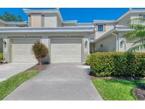 Inviting two-story townhouse featuring a two-car garage, well-maintained landscaping, and a neutral color scheme at 3433 Grand Vista Ct # 102, Port Charlotte, FL 33953