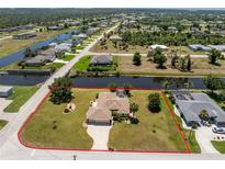 Beautiful aerial view of a canal-front property featuring a private pool, mature landscaping, and water access at 4 Pine Valley Ln, Rotonda West, FL 33947