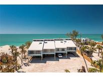 Stunning aerial view of a beachfront home featuring a modern design and beautiful ocean views at 5030 N Beach Rd # 1, Englewood, FL 34223