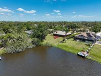 Beautiful aerial view of waterfront home with a dock and lush greenery at 6305 Shalimar St, Port Charlotte, FL 33981
