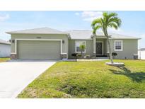 Charming single-story home featuring a two-car garage, a lovely lawn, and a mature palm tree at 7089 Benson St, Englewood, FL 34224