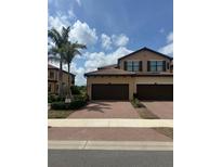 Charming two-story townhome with a two-car garage and a beautifully paved driveway at 10805 Tarflower Dr # 101, Venice, FL 34293