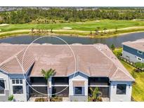 A stunning building showcasing large screened lanais for relaxing outdoor living, surrounded by lush landscaping at 12470 Wellen Golf St # 207, Venice, FL 34293