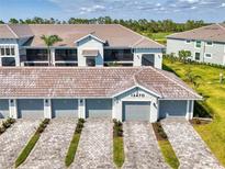 Beautiful two-story home featuring a paved driveway and attached garages for convenient parking at 12470 Wellen Golf St # 208, Venice, FL 34293