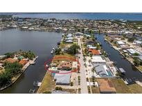 Aerial view of canal-front home featuring pool and waterfront access to the Gulf at 158 Morgan Se Ln, Port Charlotte, FL 33952