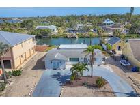 Charming waterfront home featuring a well-maintained lawn, mature palms and a private drive at 17 Southwind Dr, Englewood, FL 34223