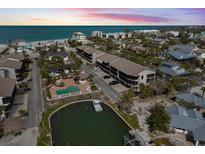 Coastal community featuring a pool, boat dock, and condos near a sandy beach and ocean at 2769 N Beach Rd # 205, Englewood, FL 34223