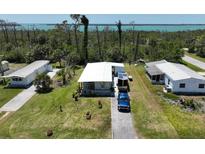 Charming single-story home with a well-maintained lawn and a scenic view of the water at 2906 Waterside Dr, Englewood, FL 34224