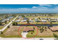 Waterfront home with mature landscaping, circular drive, and proximity to a golf course at 39 Bunker Pl, Rotonda West, FL 33947
