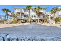 Beautiful beachfront condo complex with stairs and balcony access and lush tropical landscaping at 7470 Palm Island Dr # 2813, Placida, FL 33946