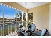 Screened balcony with outdoor seating and water views, perfect for enjoying the Florida sunshine at 8500 Amberjack Cir # 102, Englewood, FL 34224