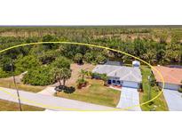 Spacious single-Gathering home with a private pool, lush backyard, and serene views of the surrounding landscape at 10182 Charlemont Ave, Englewood, FL 34224