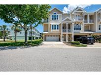 Beautiful multi-story townhouse with front yard and balconies near mature trees, and a two-car garage at 10411 Coral Landings Ln # 85, Placida, FL 33946