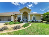 Charming single-story home with manicured lawn and a decorative front water fountain at 169 Fairway Rd, Rotonda West, FL 33947