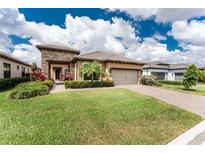 Beautiful single-story home with manicured lawn and stone accents at 257 Corelli Dr, Nokomis, FL 34275